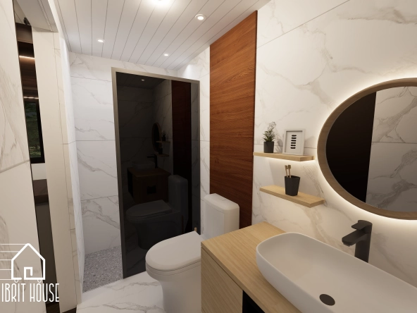 Küçük bir alanda, modern armatür ve duş bölmesine sahip işlevsel banyo.