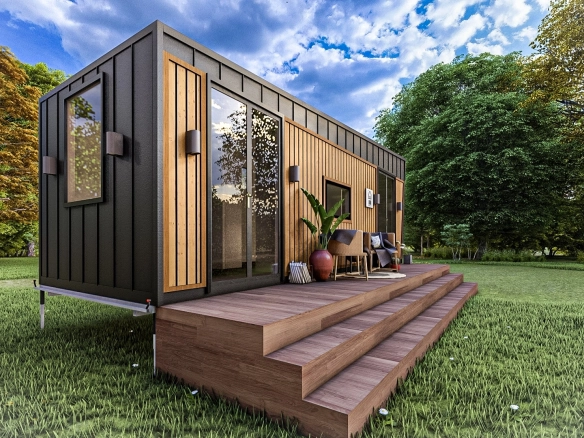 Pitch Black 7M tek katlı 1+1 römorklu tiny house, geniş ahşap verandası ve siyah metal kaplamasıyla ön-yan cepheden görünüm.
